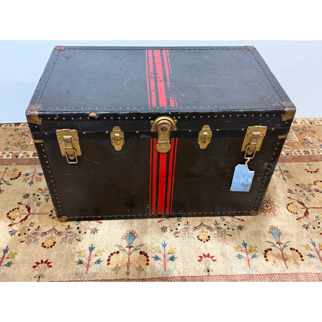 Design Plus Gallery presents an Antique Steamer Trunk in Black with Red Accents + Antique Brass Hardware. This steamer is...