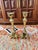 Elegant pair of solid brass candlesticks featuring ornate Baroque-inspired scroll bases and faceted stems. Likely crafted...
