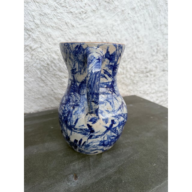 Vintage Jerry Brown Hamilton hand crafted pitcher with blue splatter glaze. The bottom of the pitcher is incised with the...