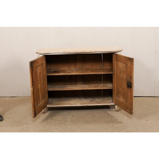 An Italian two-door cabinet with artistic hand-painted finish, from the 19th century. This antique cabinet from Italy...