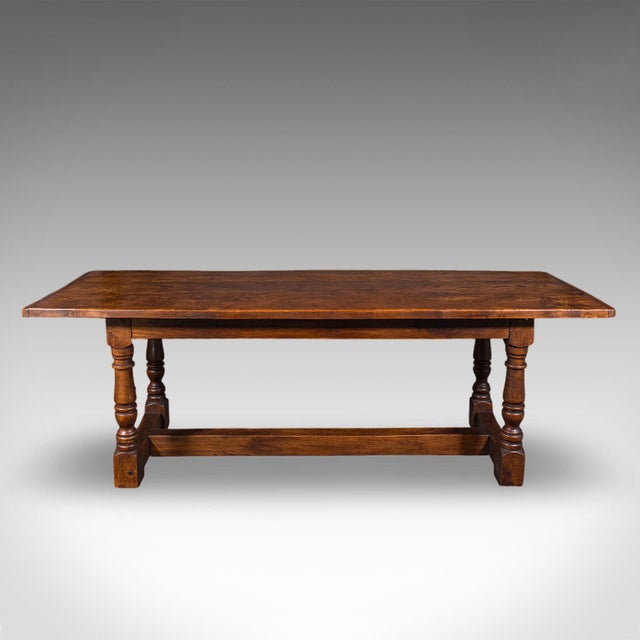 This is an antique farmhouse table. An English, elm country kitchen refectory or dining table, dating to the late...
