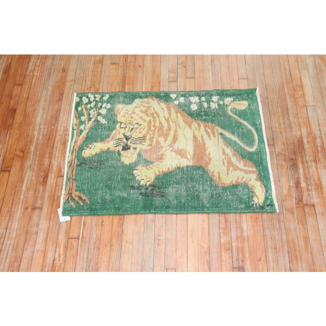 One of a Kind Vintage one-of-a-kind scatter size hand-knotted wool Turkish Rug depicting a roaring Lion on a green field.