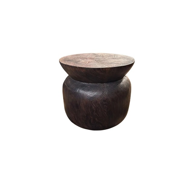 A wonderfully sculpted side table, crafted from solid teak wood. It features wonderful wood textures as well as a...