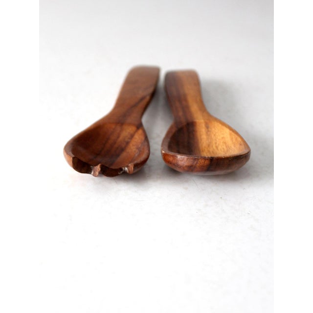 Handcrafted mid-century wood salad servers featuring a smooth, ergonomic design and rich natural wood grain. Perfect for...