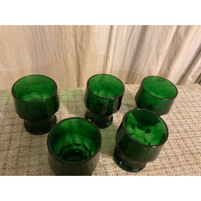 These beautiful deep green 70s glasses and in good condition .