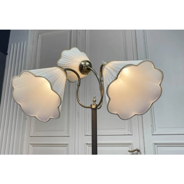 Elegant mid-century design featuring three pleated white fabric shades, each individually controlled for adjustable...