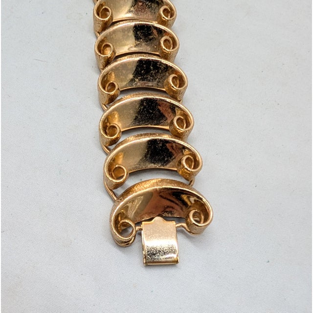 1950s goldtone crescent shaped links that are textured on the outside, smooth on the inside and curled on the edges...