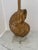 Unique seashell form table lamp in gilt finish resting on a lucite base. The base is constructed of a circular lucite base...