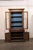 A tall wood Italian display hutch and cabinet from the 18th century. This antique bookcase from Italy, approximately 7.75...