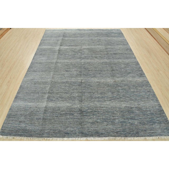This fine contemporary area rug is hand-knotted with an all-wool pile on a cotton foundation. This rug is new and in...