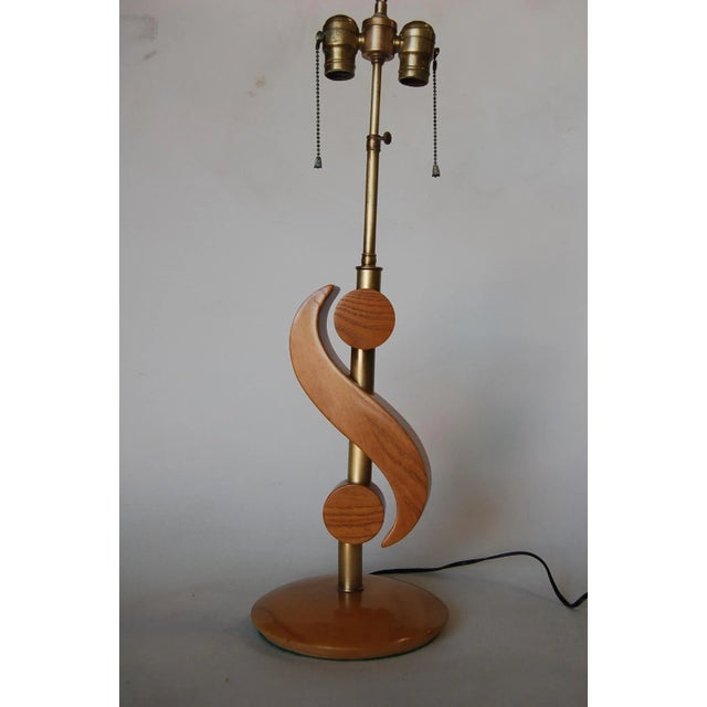 Pair of carved oak and brass modernist "S" biomorphic table lamps each with a double pull chain. Measures 25" High x 6.5"...