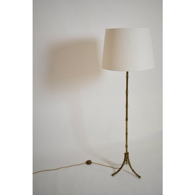 Jansen tripod faux bamboo solid brass floor lamp, 1960s. Length (cm): 126 Diameter (cm): 45 Height with lamp shade (cm):...