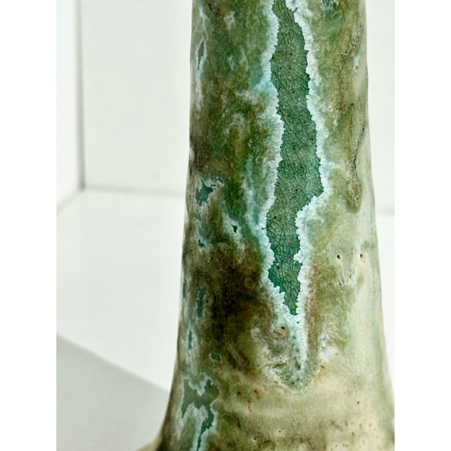 Elegant, hand-thrown ceramic candlestick from the 1970s with an unknown signature. The slender, slightly conical form is...