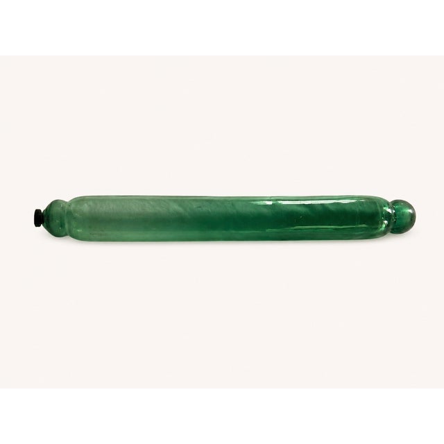 A beautiful and authentic antique blown glass rolling pin in a pretty green hue, designed with a hollow interior that can...