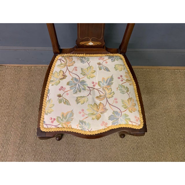 A lovely Art Nouveau period inlaid mahogany chair. Well constructed in solid mahogany and inlaid with stylised floral...