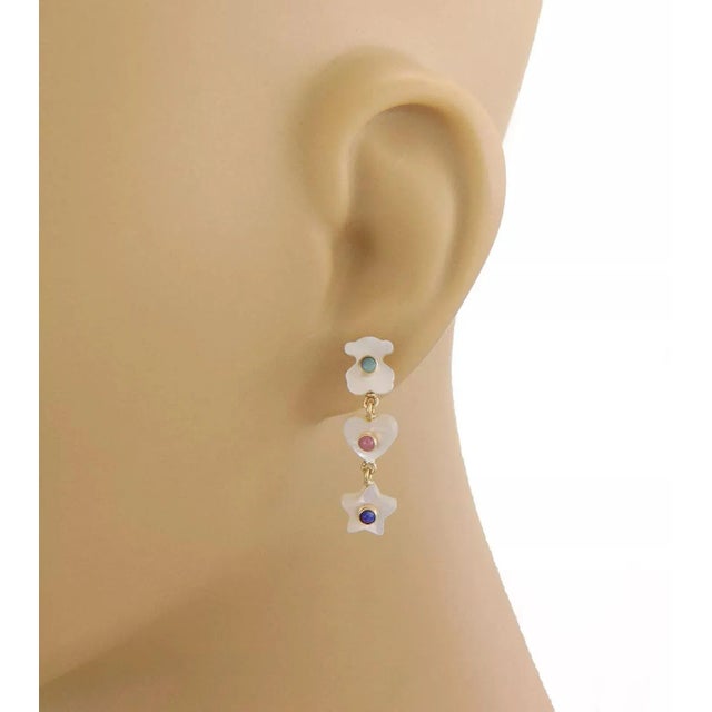 This is an adorable authentic pair of earrings from designer Tous, crafted from 18k yellow gold featuring mother of pearl...