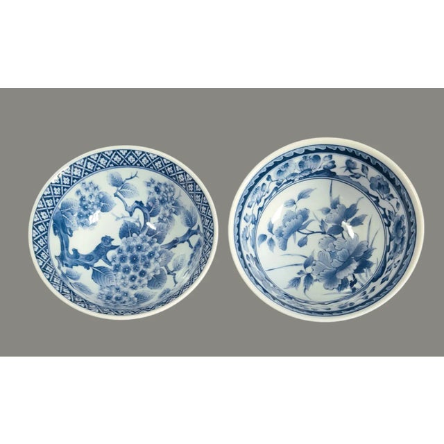 Discover the elegance of Japanese craftsmanship with these Vintage Blue and White Porcelain Floral Serving Bowls. Marked...