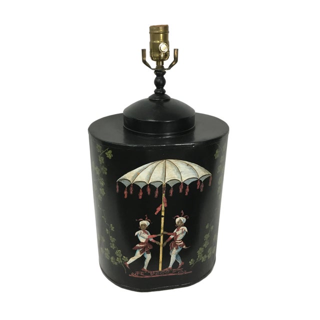 Handpainted whimsical design featuring two red and white figures under an umbrella surrounded by trees in front of a black...