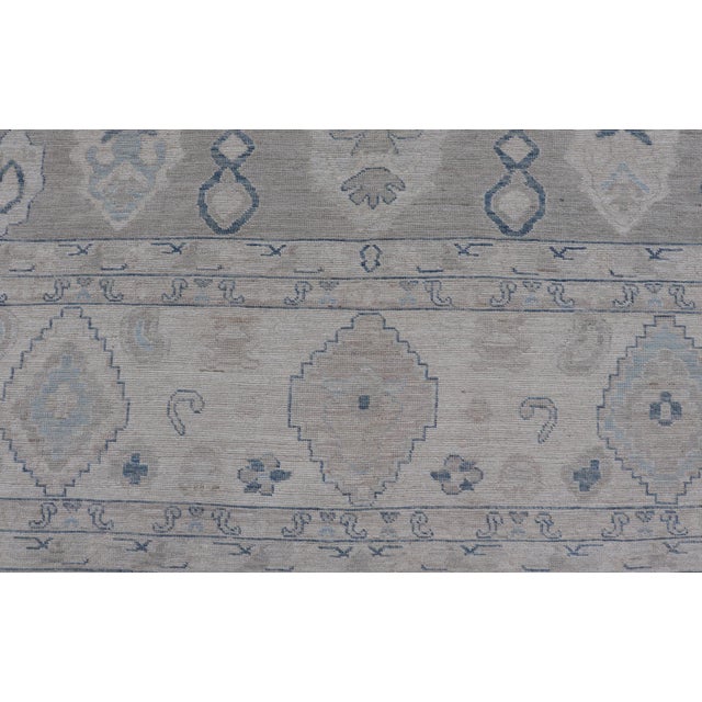 Turkish Oushak Rug With Soft Gray Field and Pale Blue Geometric Motifs For Sale - Image 13 of 16