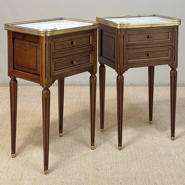 Pair French Louis XVI Marble Top End Tables are perfect for accompanying any seating group, or as bedside companions. The...