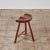 Teak tripod milking stool. The stool features a thick hand carved rounded seat that sits atop three teak turned legs with...