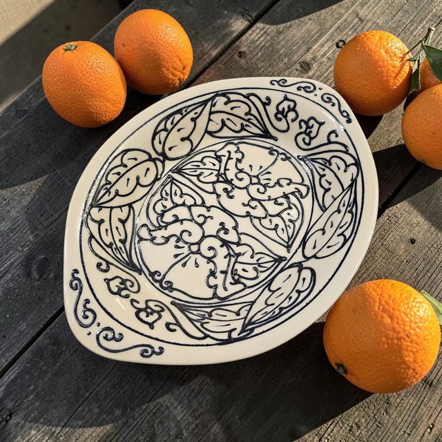 A large late twentieth-century American studio-pottery serving platter, circa 1980s–1990s, formed as a substantial oval...