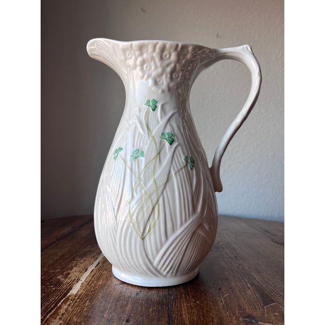 Belleek Pottery Pitcher Daisy Pattern Made in Ireland Description: Embossed Daisies, Green Shamrocks 9" height 48 oz No...