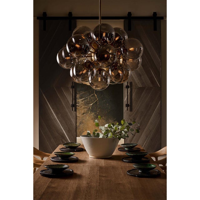 The Shine Chandelier is a beacon of joy, evoking the whimsy of a cluster of balloons with a nod to mid-century modern...