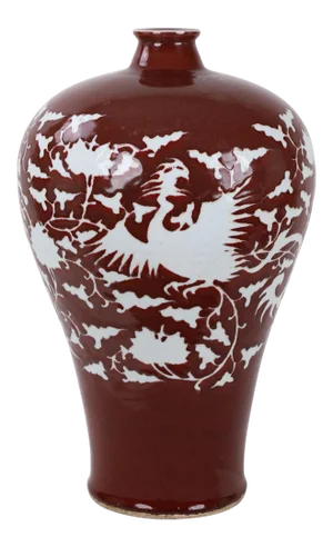 Early 20th-Century Chinese Red-Glazed Vase With Carved White Phoenix and Floral Motifs.