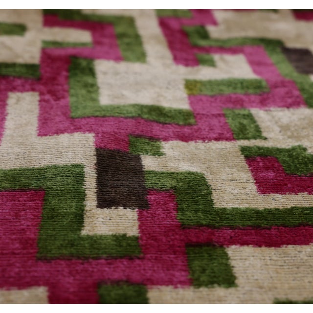 "Bold color, architectural geometry, and artisan craftsmanship come together in this striking handmade silk velvet pillow....
