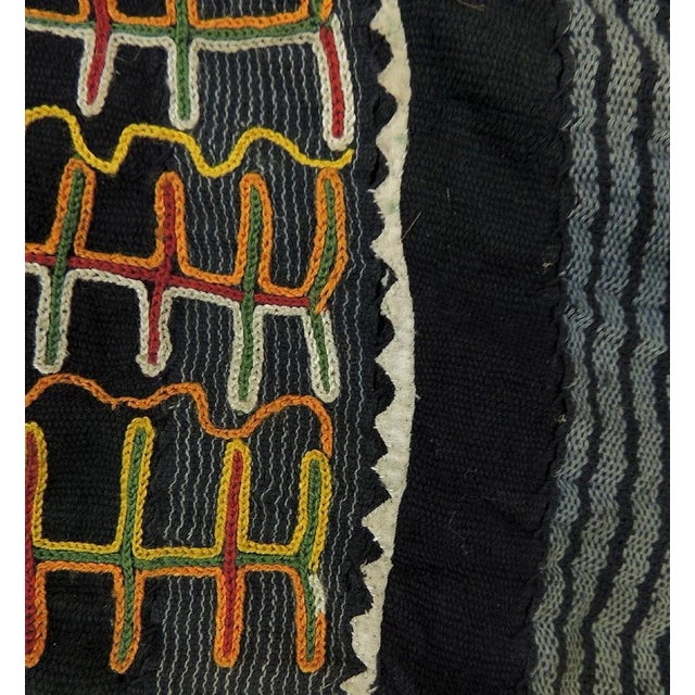 A small tunic or shirt crafted from cotton cloth possibly died with indigo. The indicative aspect of the garment is the...