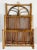 Unique vintage deep pocket rattan magazine rack. Features rich burnt tortoise shell finish. Brass hanging hardware makes...