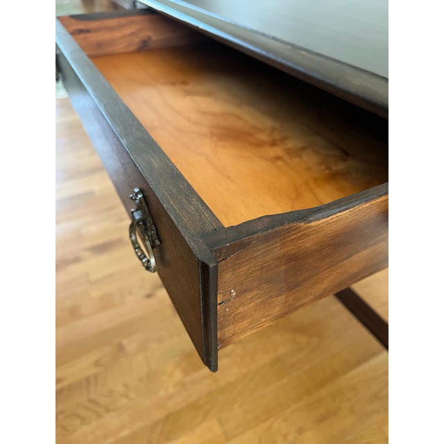 Early American Colonial Walnut Writing Desk. Turned legs with a stretched support, with solid brass drawer pulls. This...