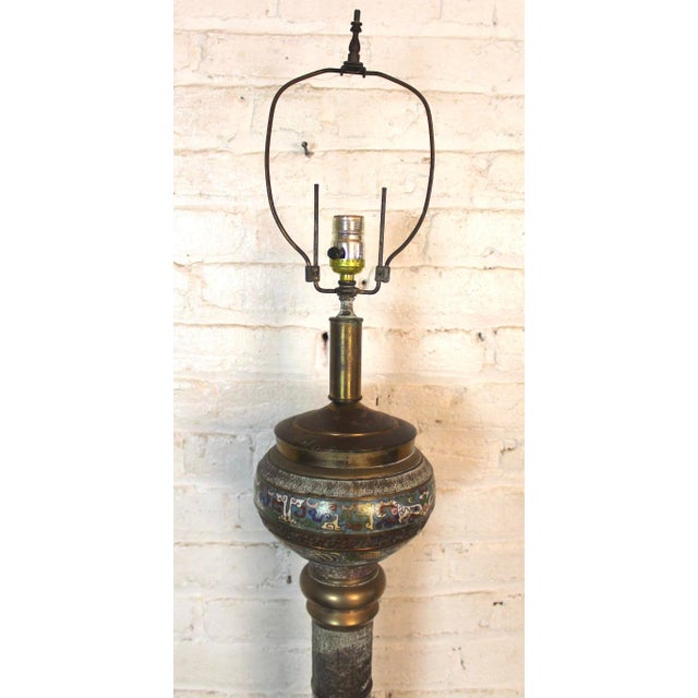 Tall floor lamp with highly decorated enameled figures set in brass. Colorful Asian motifs along with etched patterns.