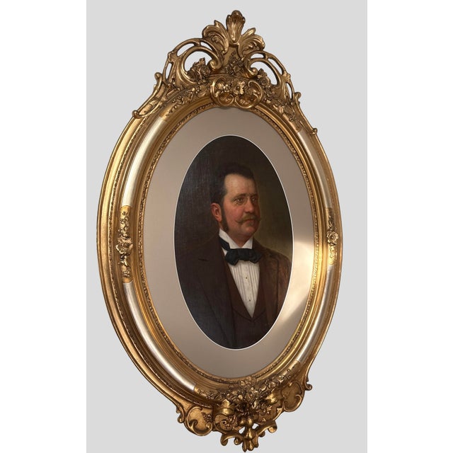 Monumental late 19th-century oil on canvas portrait presented in an elaborate hand-carved wooden Rococo Revival frame with...