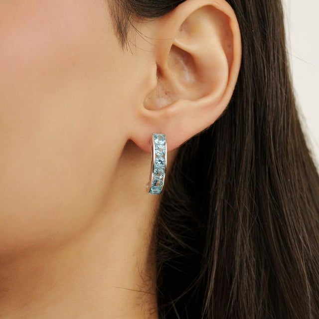 Crafted in luminous 925 sterling silver, these elegant bar earrings showcase the fresh brilliance of natural blue topaz in...