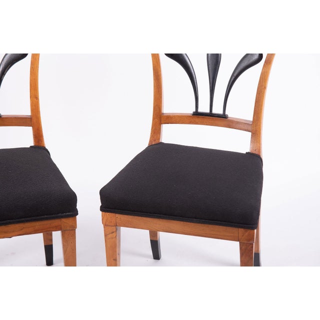 Pair of Antique Biedermeier Style Side Chairs. Curved headrail above ebonized fan form back splats above a dark...