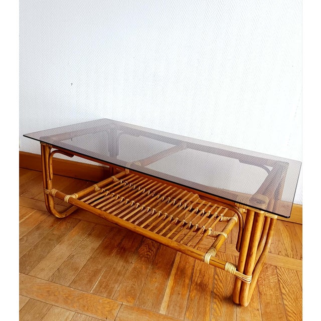 Large rectangular coffee table, vintage design circa 1960. Rattan frame with stretcher and large rectangular smoked glass...