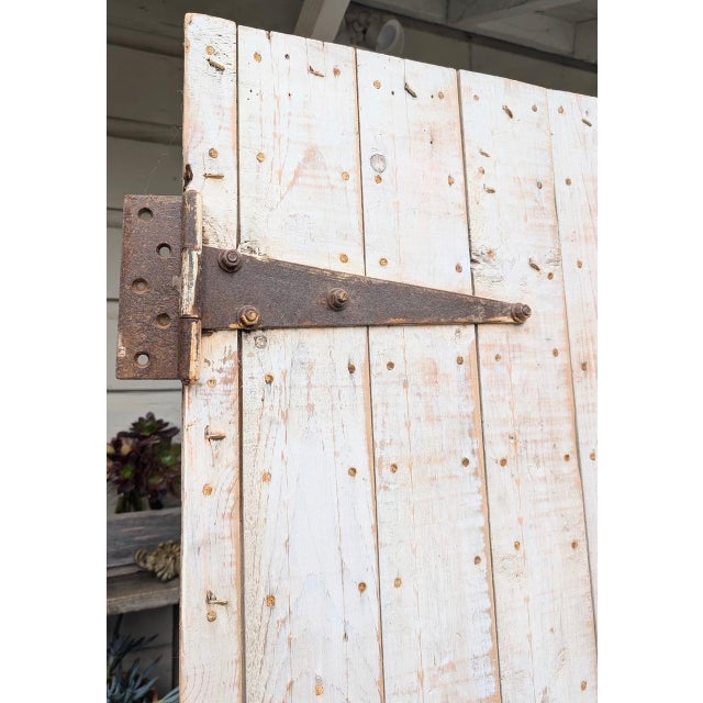 Stunning pair of authentic vintage solid wood barn doors. Both sides of the doors are different and incredibly gorgeous.