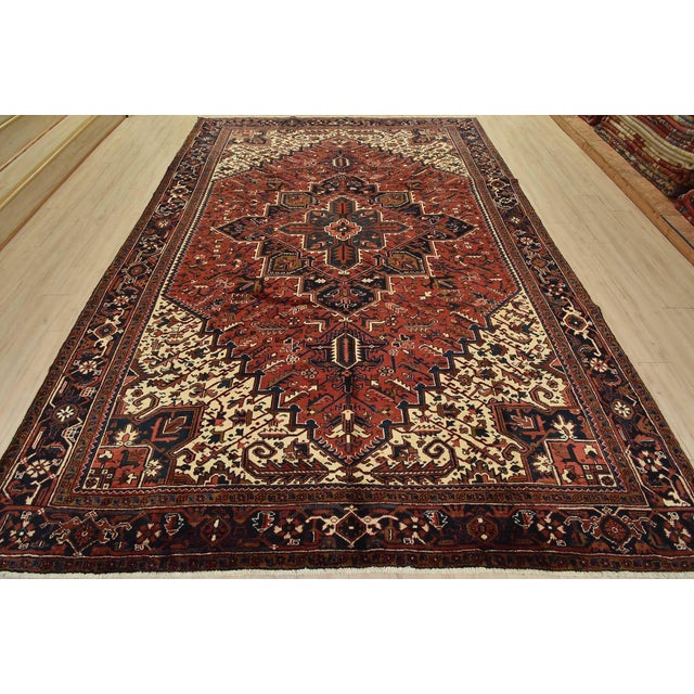 An authentic vintage traditional tribal Heriz rug hand-knotted with fine wool and natural dyes. This oriental rug features...