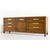 Commanding in scale and refined in detail, this mid-century Campaign style credenza by Fancher Furniture is a rare find...