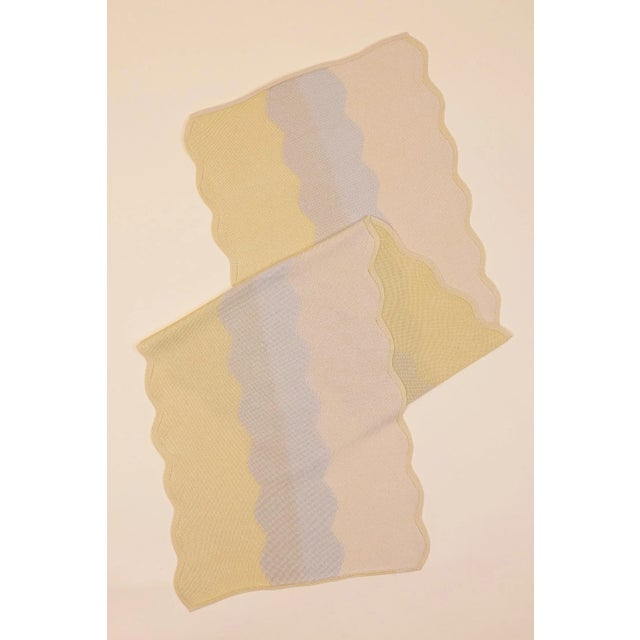 With its graceful wavy edges, this sustainable knitted table runner adds a stylish touch to your table decor. The unique...