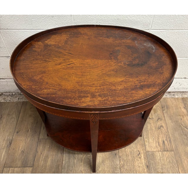 This is a beautiful vintage mahogany Hepplewhite style tiered mahogany inlay oval end table, side table, or lamp table by...