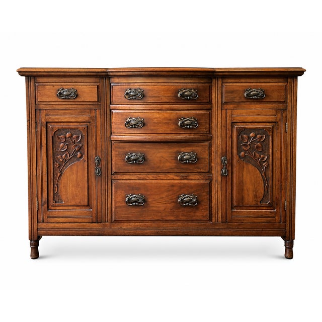 A beautifully proportioned English Edwardian walnut sideboard dating from the early twentieth century, combining elegant...