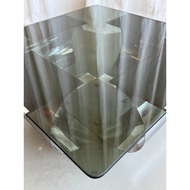 Beautiful stainless steel coffee table with smoked glass top attributed to Francois Monnet for Kappa, 1970s. Archetypal...
