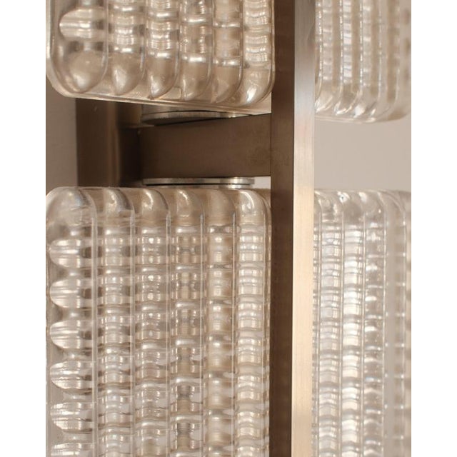 A sculptural and rare pair of mid-century italian sconces (circa 1950s–1960s) plays with light and texture like...