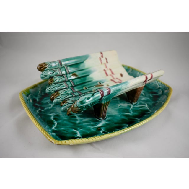 A fabulous and scarce seaside themed rustic English majolica, large asparagus cradle with an attached under tray, maker...