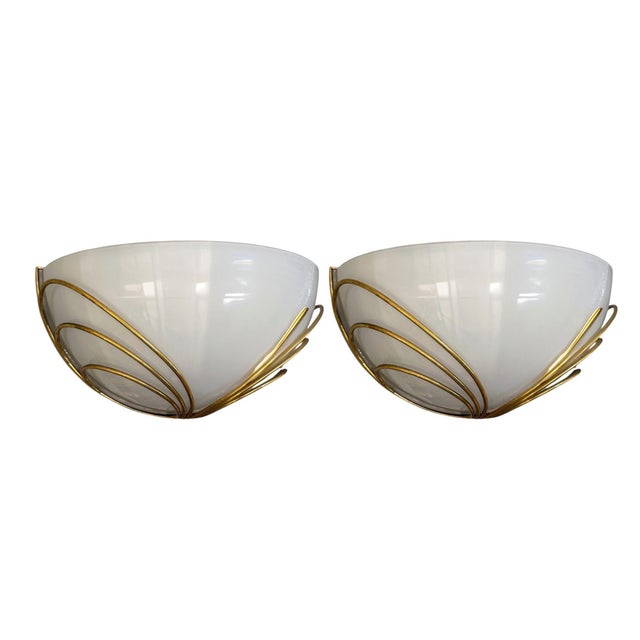 A sophisticated pair of Italian Mid-Century Modern wall sconces, circa 1960s, distinguished by their sculptural half-moon...
