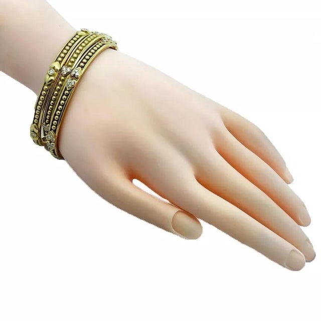 These authentic set of 3 bangles are by Judith Ripka, they are crafted from 18k yellow gold with a smooth satin finish,...