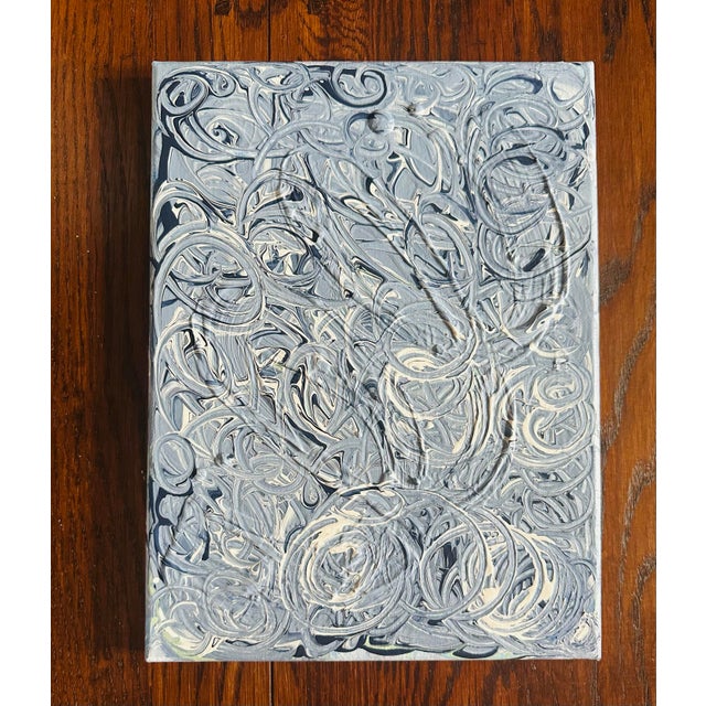 This is a textured blue and white canvas painting. The paint has 3D elements which create a sculptural effect. The organic...